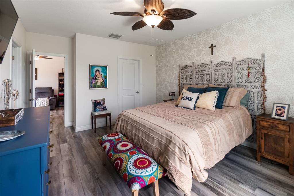 8990 Indigo Trail Loop Riverview, FL 33578 - Photo 31 of 43 a bedroom with a bed and a chandelier