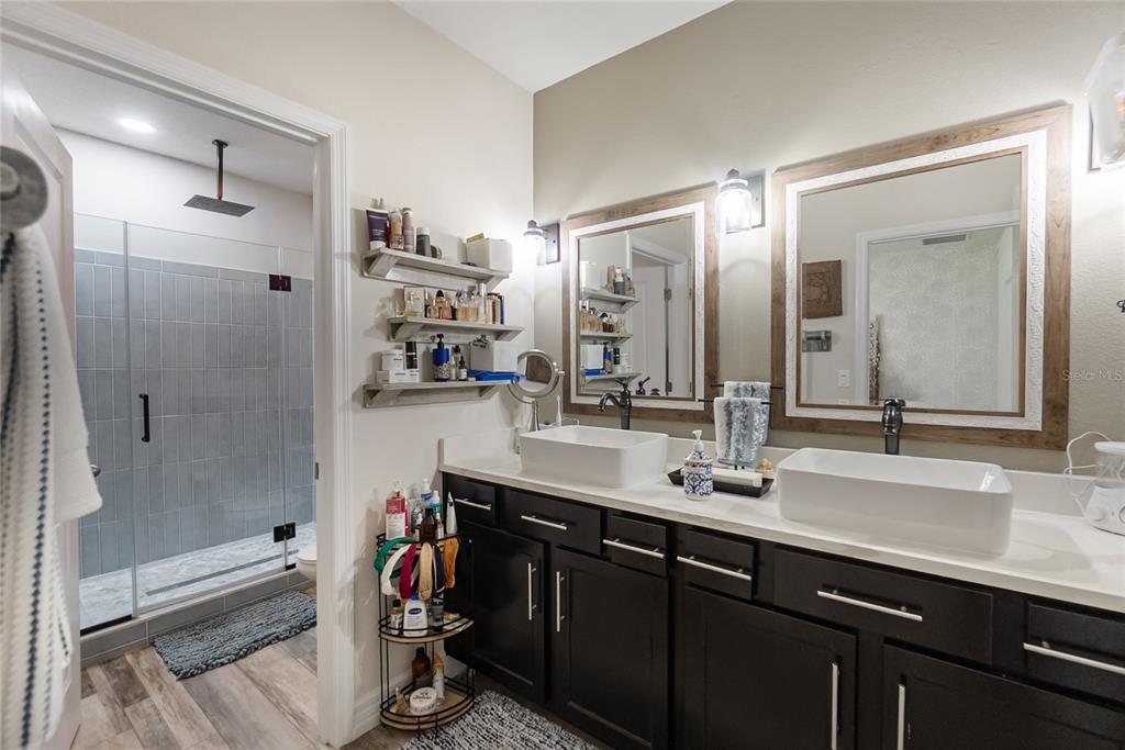 8990 Indigo Trail Loop Riverview, FL 33578 - Photo 33 of 43 a bathroom with a double vanity sink mirror and shower