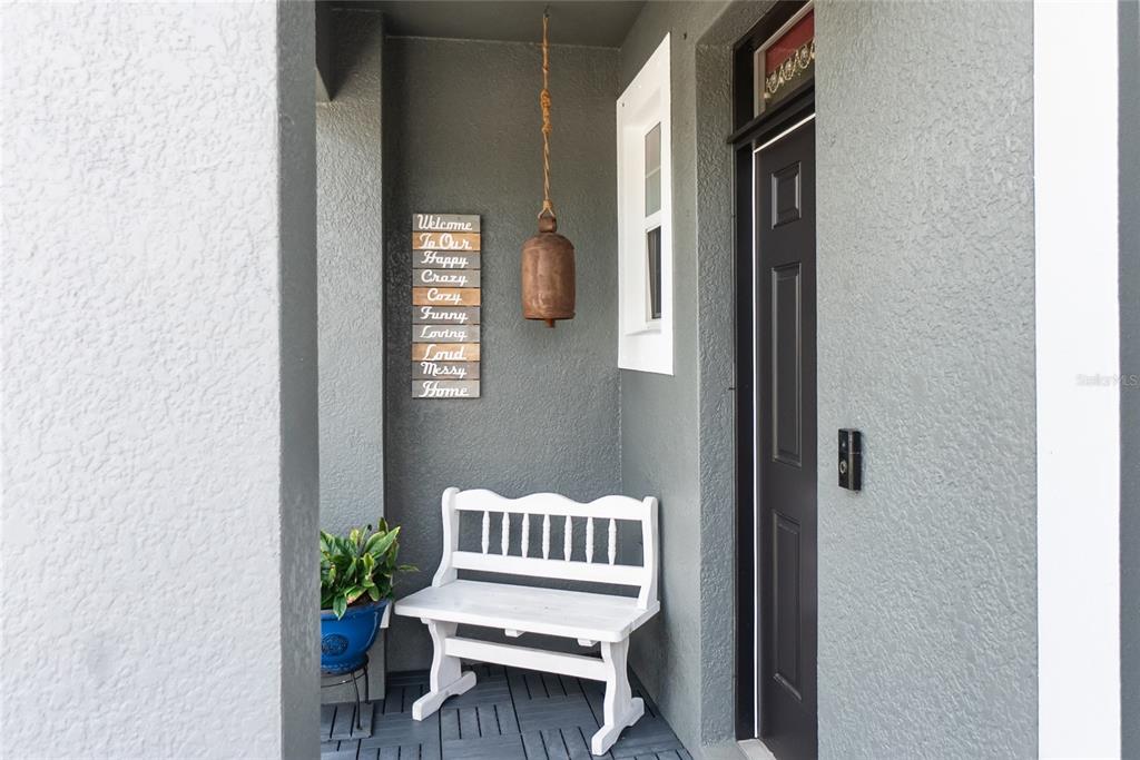 8990 Indigo Trail Loop Riverview, FL 33578 - Photo 4 of 43 a balcony with table and chairs
