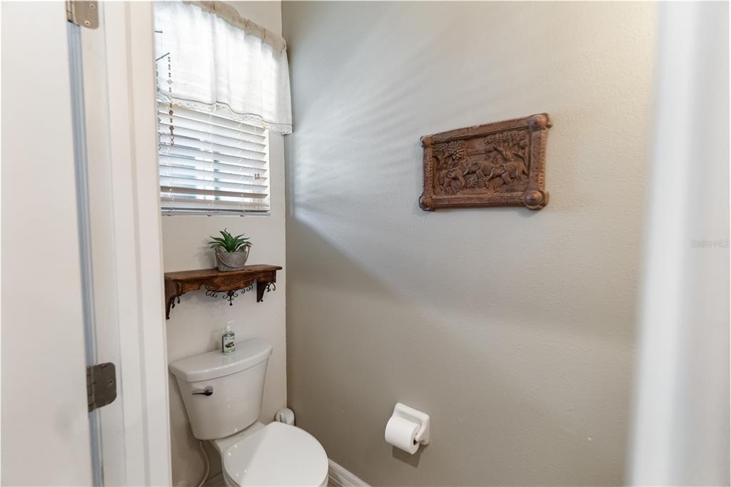 8990 Indigo Trail Loop Riverview, FL 33578 - Photo 6 of 43 a white toilet sitting next to a bathroom sink