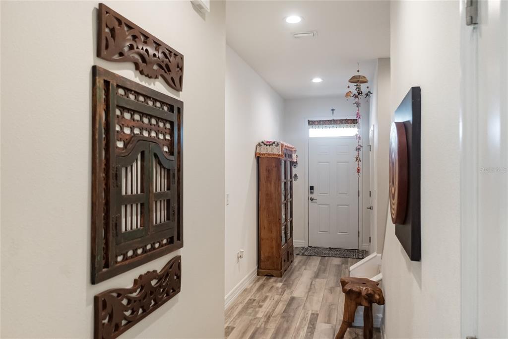 8990 Indigo Trail Loop Riverview, FL 33578 - Photo 8 of 43 a view of a hallway with wooden floor