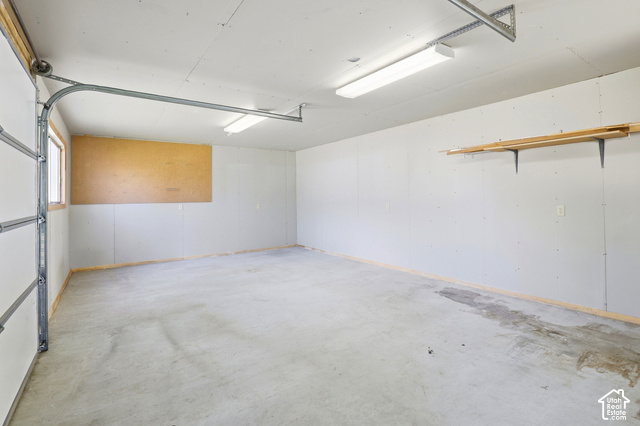 380 North 300 East Mapleton, UT 84664 - Photo 26 of 35 Concrete flooring, overhead fluorescent lighting, built-in wall shelving, and a window
