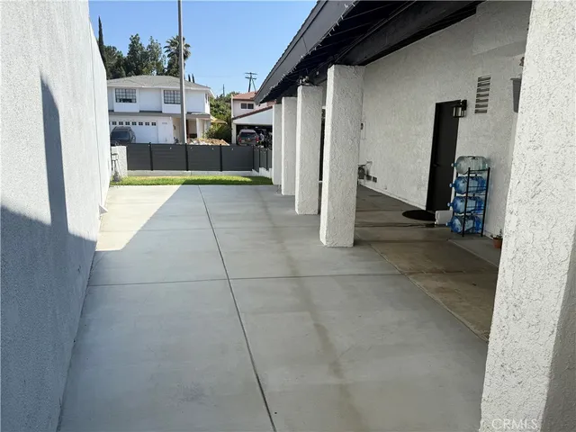a living room with furniture a flat screen tv and a large window