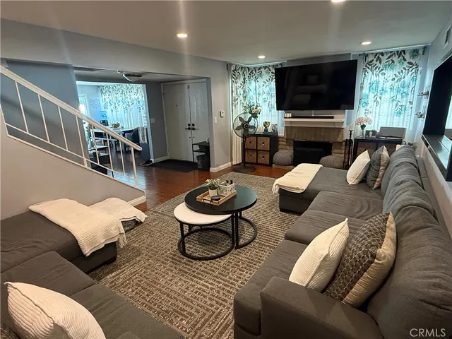 a living room with furniture and a wooden floor