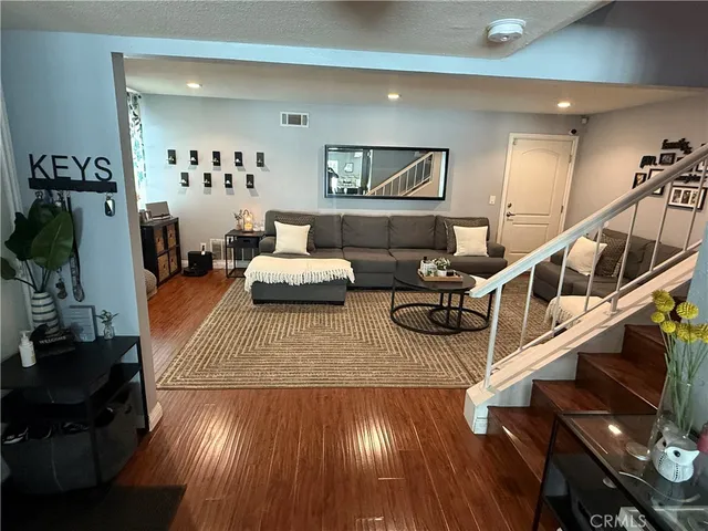 a kitchen with stainless steel appliances granite countertop a sink refrigerator dining table and chairs