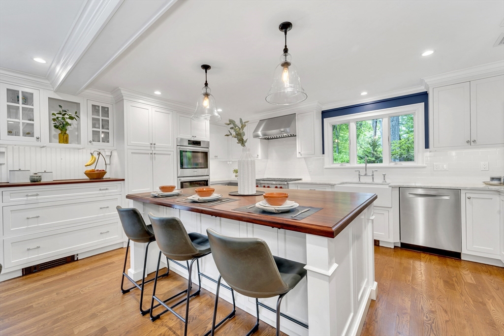 119 Pleasant Valley Road Amesbury, MA 01913 - Photo 1 of 42 a kitchen with stainless steel appliances granite countertop wooden floor window and cabinets