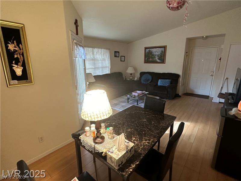 1830 North Pecos Road, Unit 230 Las Vegas, NV 89115 - Photo 5 of 16 Blonde hardwood flooring flows through this open-concept living space, leading to a front entry.