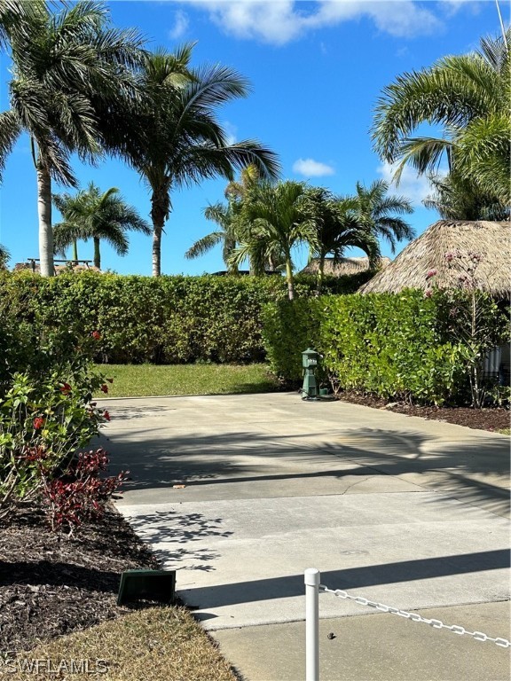 13581 Snapper Lane Naples, FL 34114 - Photo 11 of 34 a front view of a house with a yard and potted plants