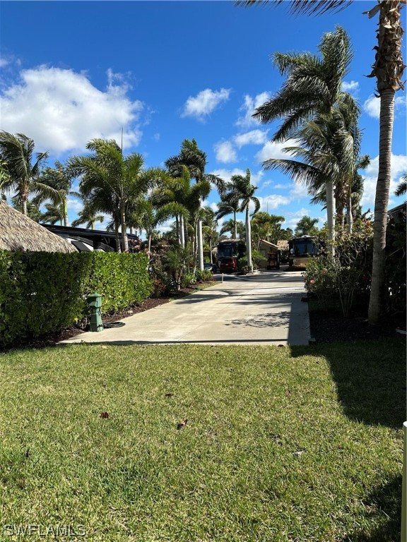 13581 Snapper Lane Naples, FL 34114 - Photo 12 of 34 a swimming pool with outdoor seating and yard