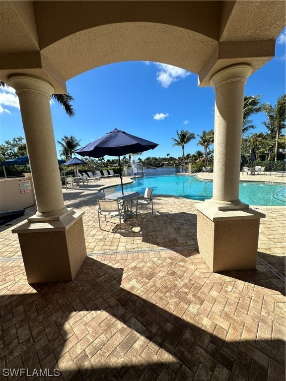 13581 Snapper Lane Naples, FL 34114 - Photo 21 of 34 a view of a patio with chairs and umbrellas
