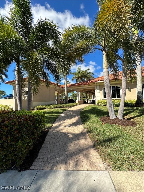 13581 Snapper Lane Naples, FL 34114 - Photo 22 of 34 a view of a white house with a yard plants and palm trees