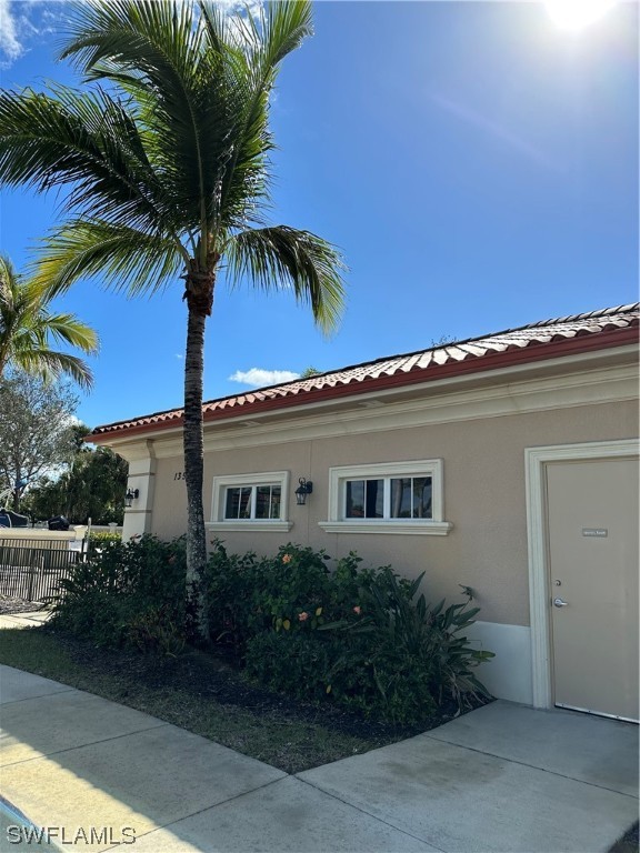 13581 Snapper Lane Naples, FL 34114 - Photo 28 of 34 a house with a palm tree in front of it