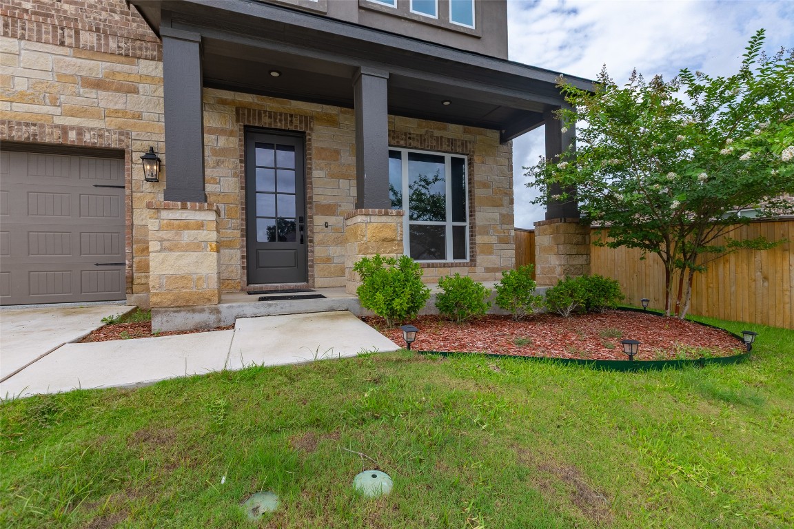 103 Periwinkle Lane Bastrop, TX 78602 - Photo 2 of 35 a front view of a house with a yard