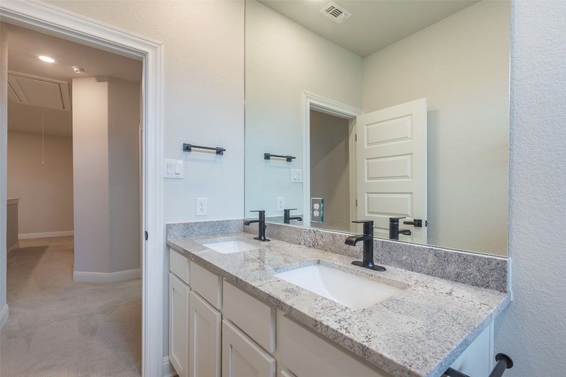103 Periwinkle Lane Bastrop, TX 78602 - Photo 24 of 35 a bathroom with a granite countertop sink and a mirror
