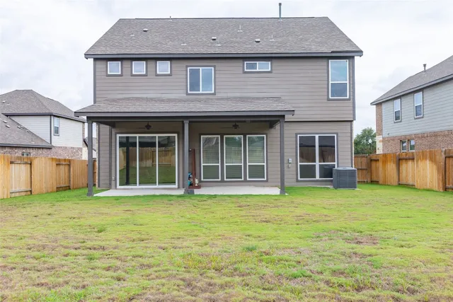 a view of a patio with a table and chairs under an umbrella