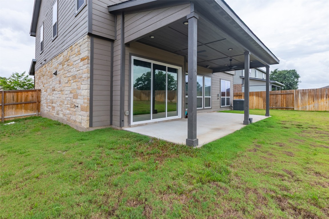 103 Periwinkle Lane Bastrop, TX 78602 - Photo 33 of 35 a view of a patio with a table and chairs under an umbrella