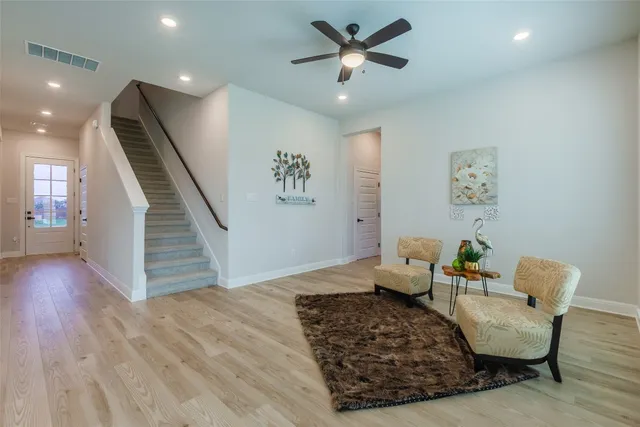 a living room with furniture and a wooden floor