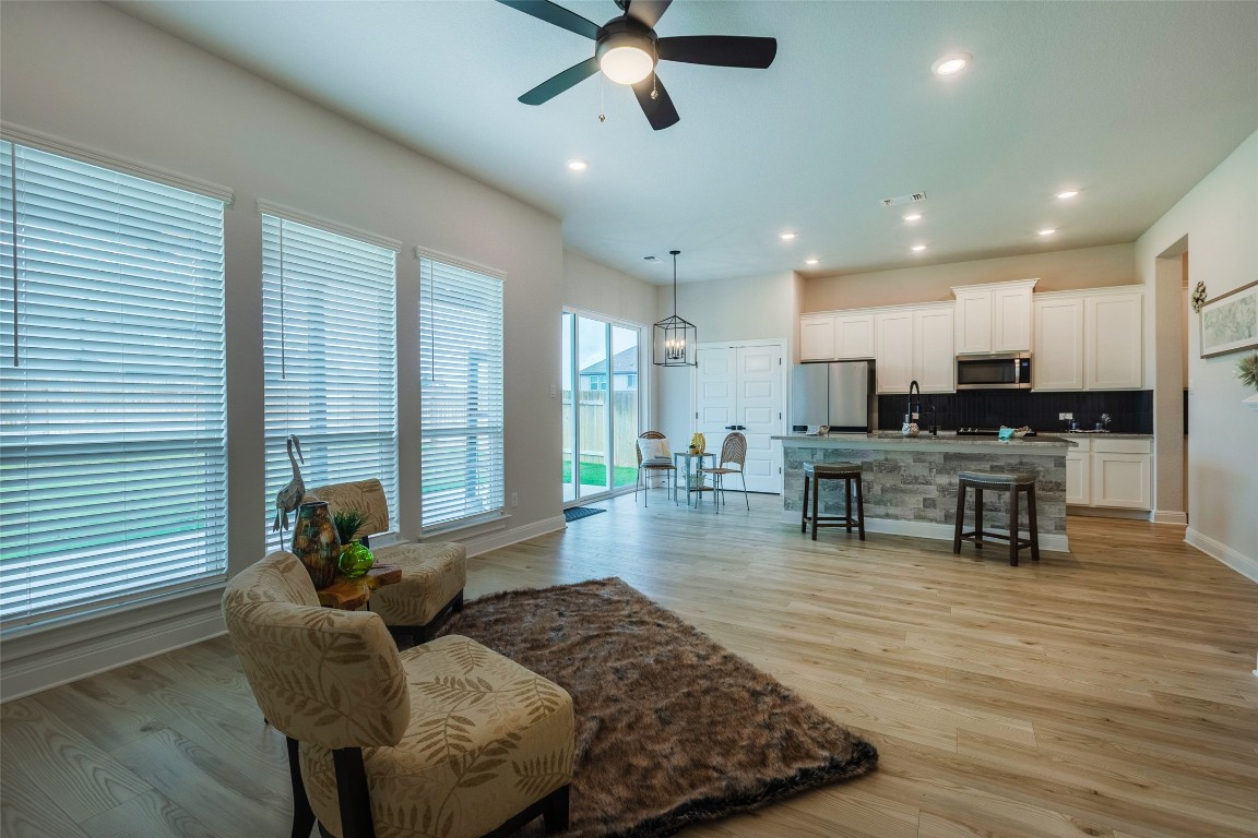 103 Periwinkle Lane Bastrop, TX 78602 - Photo 10 of 35 a living room with furniture and kitchen view with a large window