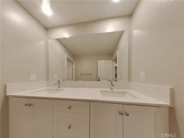 a bathroom with a sink vanity and a mirror