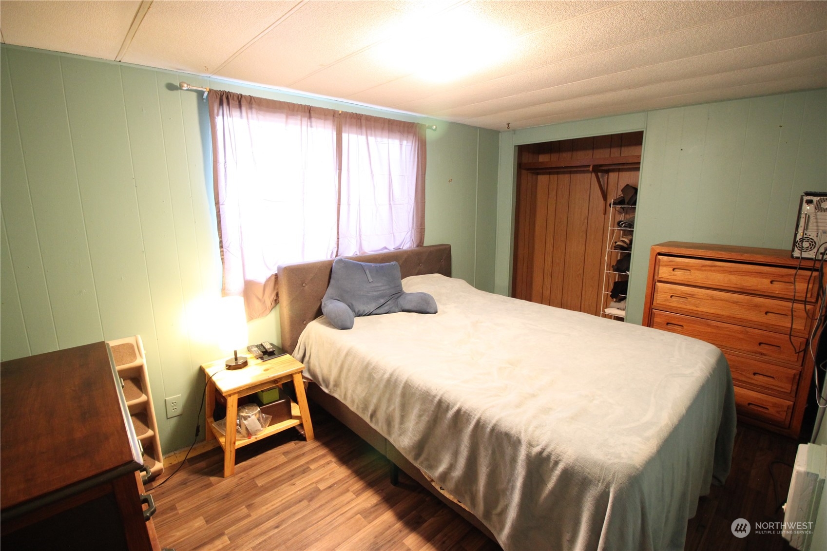 11410 Riverside Drive Southeast Olympia, WA 98513 - Photo 11 of 19 a bedroom with a bed and wooden floor