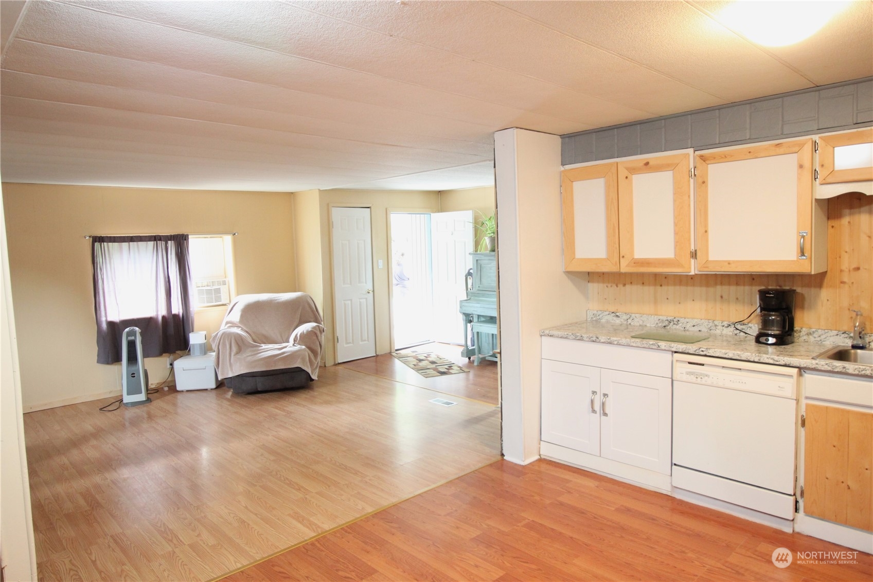 11410 Riverside Drive Southeast Olympia, WA 98513 - Photo 3 of 19 a spacious bedroom with a bed a couch and large windows