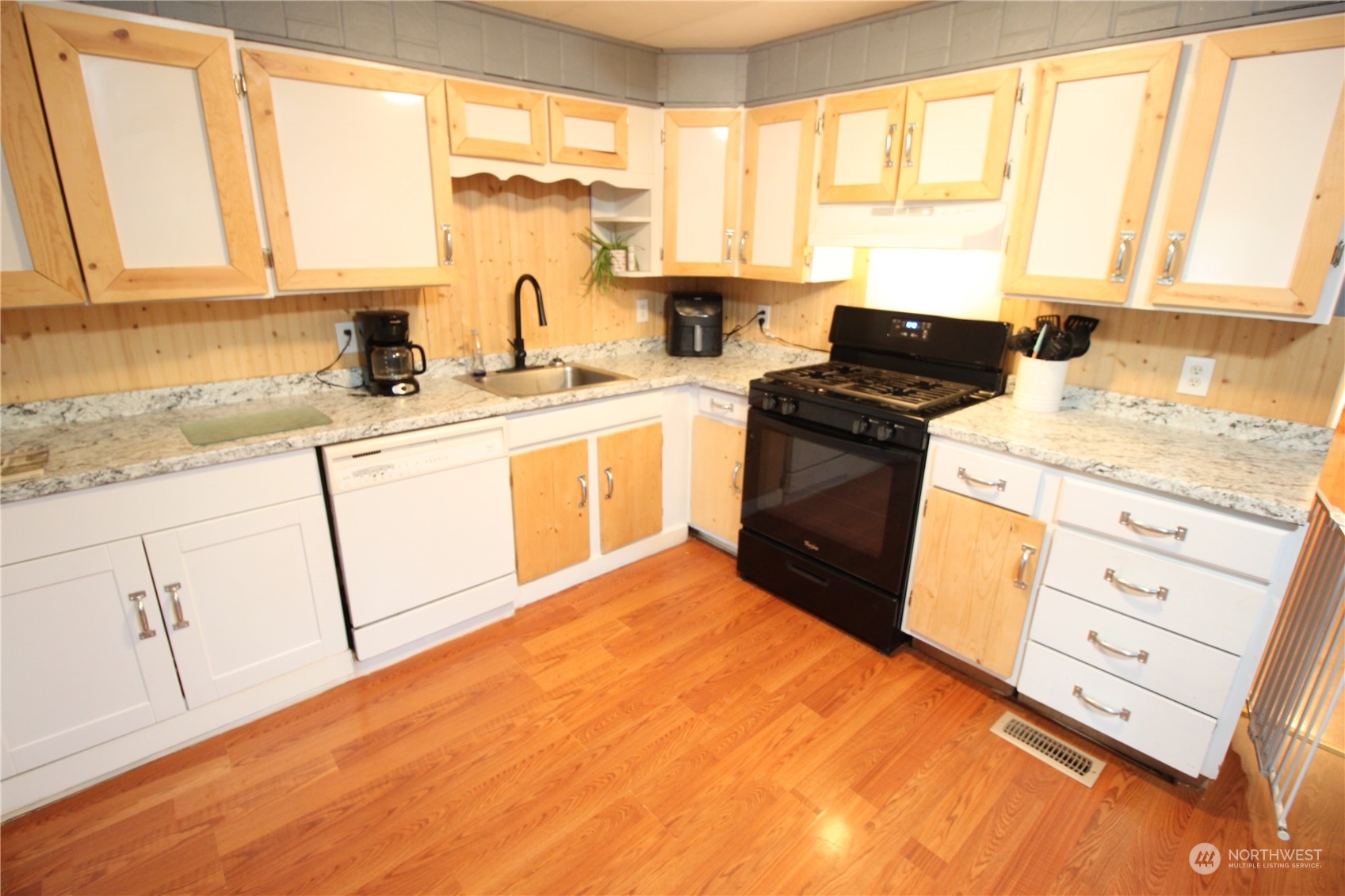 11410 Riverside Drive Southeast Olympia, WA 98513 - Photo 4 of 19 a kitchen with granite countertop a sink cabinets stainless steel appliances and a large window