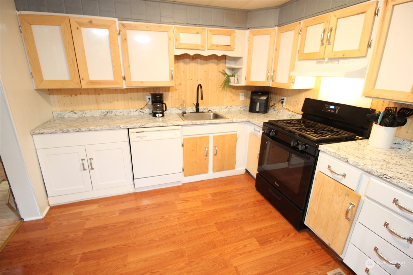 11410 Riverside Drive Southeast Olympia, WA 98513 - Photo 5 of 19 a kitchen with granite countertop a sink stove and cabinets