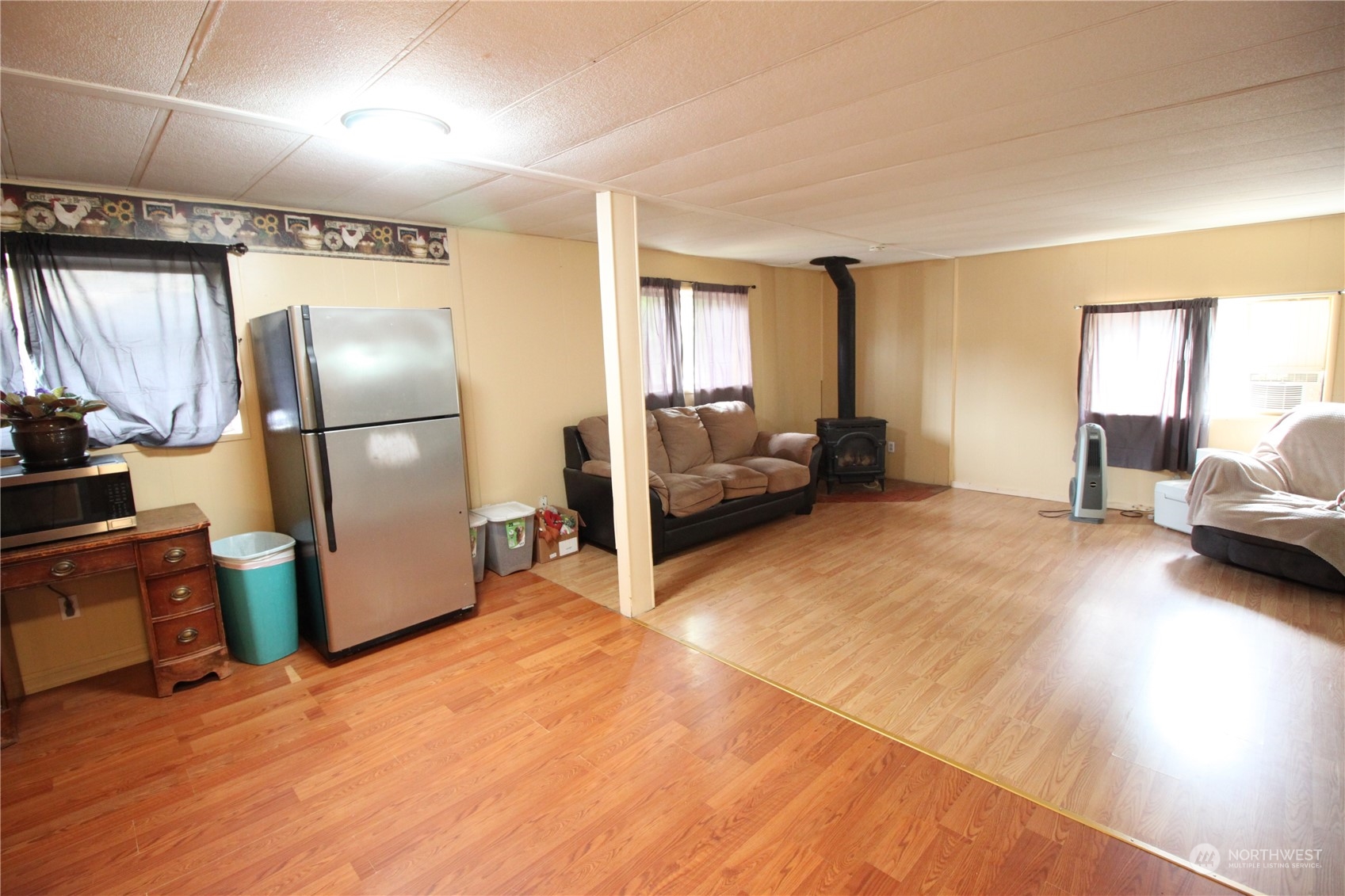 11410 Riverside Drive Southeast Olympia, WA 98513 - Photo 9 of 19 a living room with furniture and a refrigerator