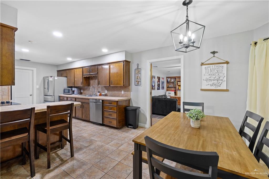 2212 North Bryan Rd Mission Mission, TX 78572 - Photo 12 of 44 a view of a dining room with furniture and wooden floor