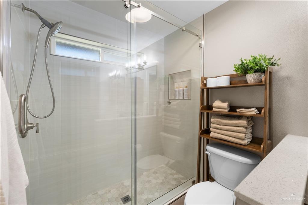 2212 North Bryan Rd Mission Mission, TX 78572 - Photo 22 of 44 a bathroom with a shower a toilet and a sink