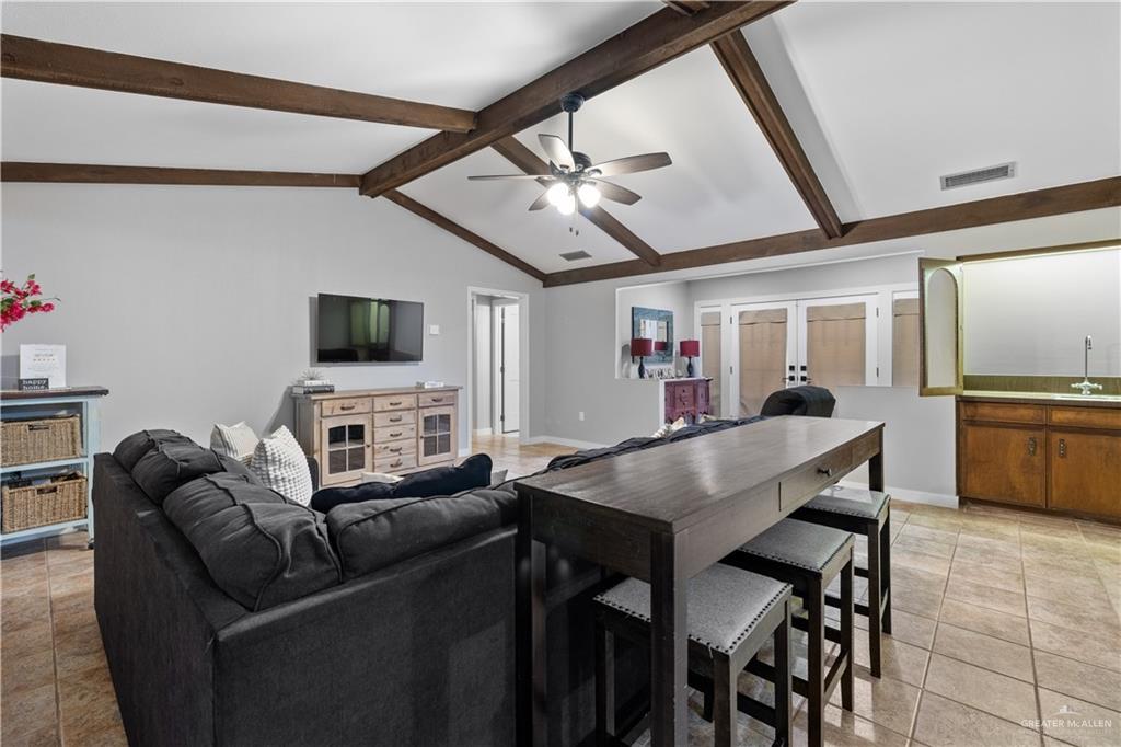 2212 North Bryan Rd Mission Mission, TX 78572 - Photo 6 of 44 a living room with furniture a flat screen tv and a kitchen view