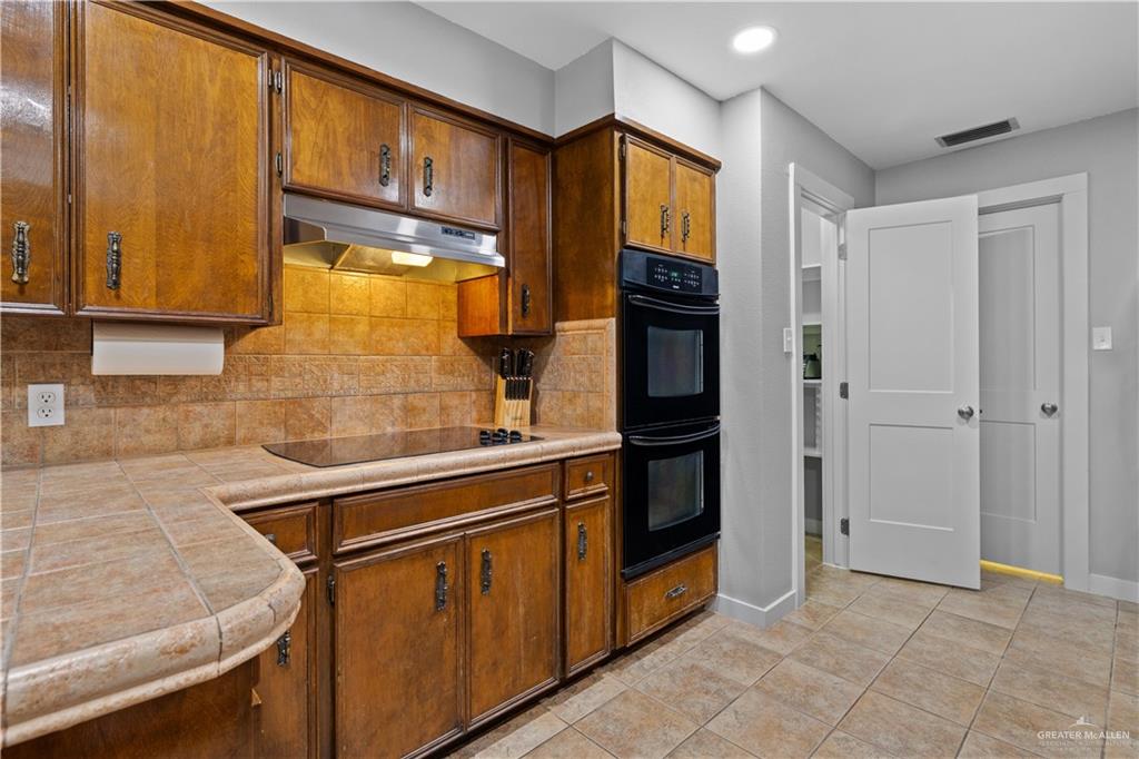 2212 North Bryan Rd Mission Mission, TX 78572 - Photo 8 of 44 a kitchen with stainless steel appliances granite countertop a refrigerator and a stove
