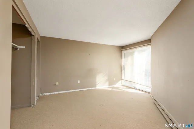 an empty room with a empty space and a window