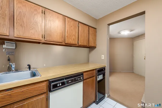 a kitchen with stainless steel appliances granite countertop a sink and a cabinets