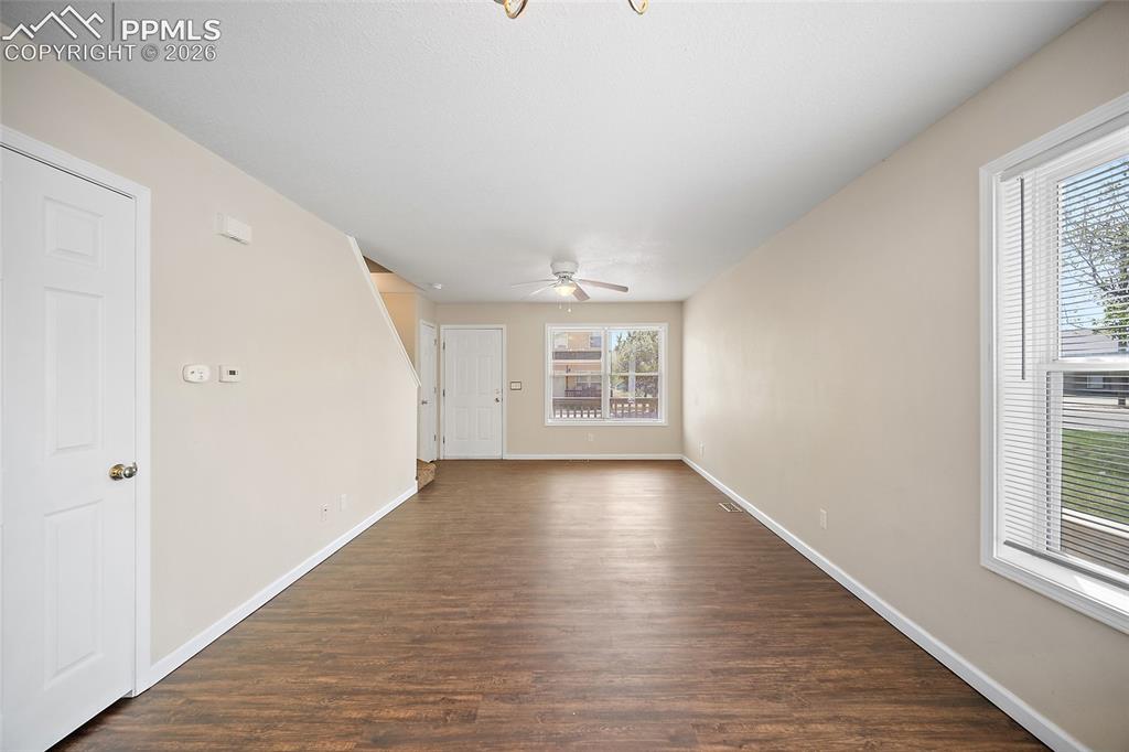 4400 Rawhide Road, Unit 157 Pueblo, CO 81008 - Photo 12 of 36 an empty room with wooden floor cabinet and windows