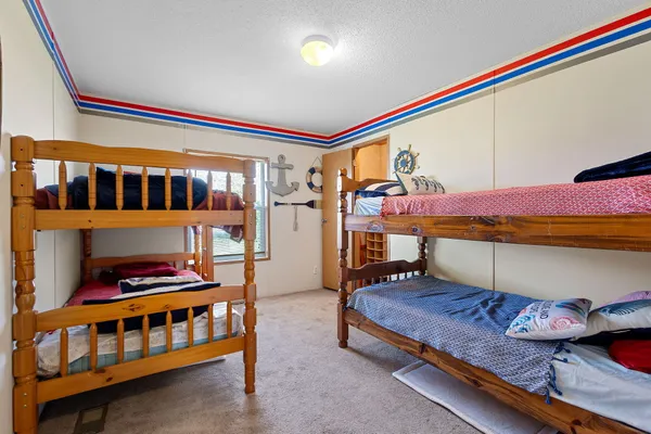 a bedroom with furniture and a baby crib