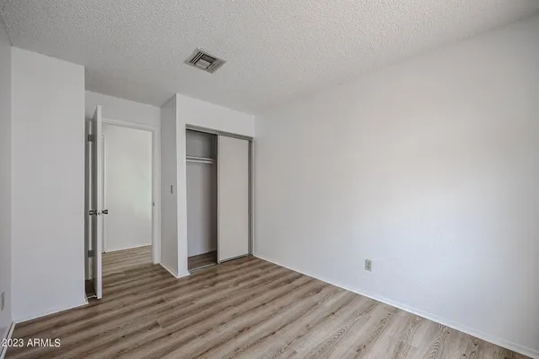 a view of a room with wooden floor and white doors