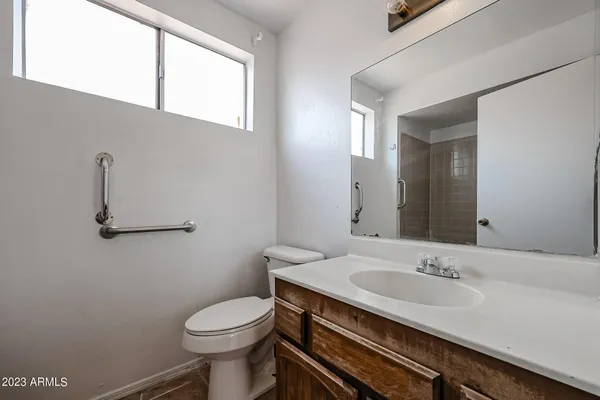 a bathroom with a sink a toilet and mirror