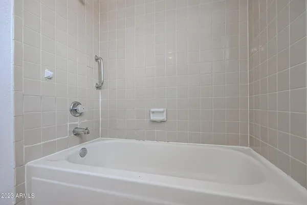a view of a backyard with couches plants and wooden fence
