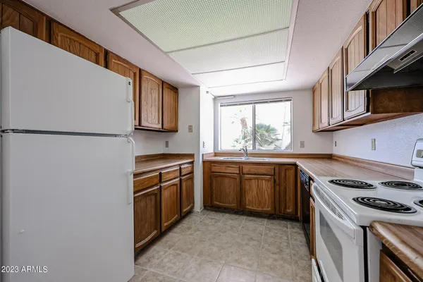 a kitchen with stainless steel appliances granite countertop a stove a sink and a refrigerator