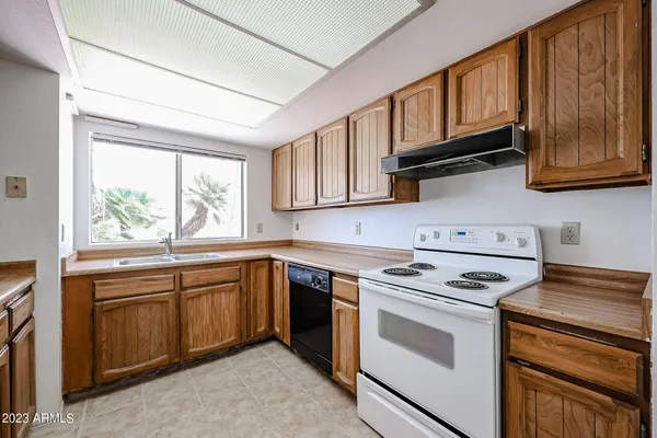 a kitchen with stainless steel appliances granite countertop a stove sink and cabinets