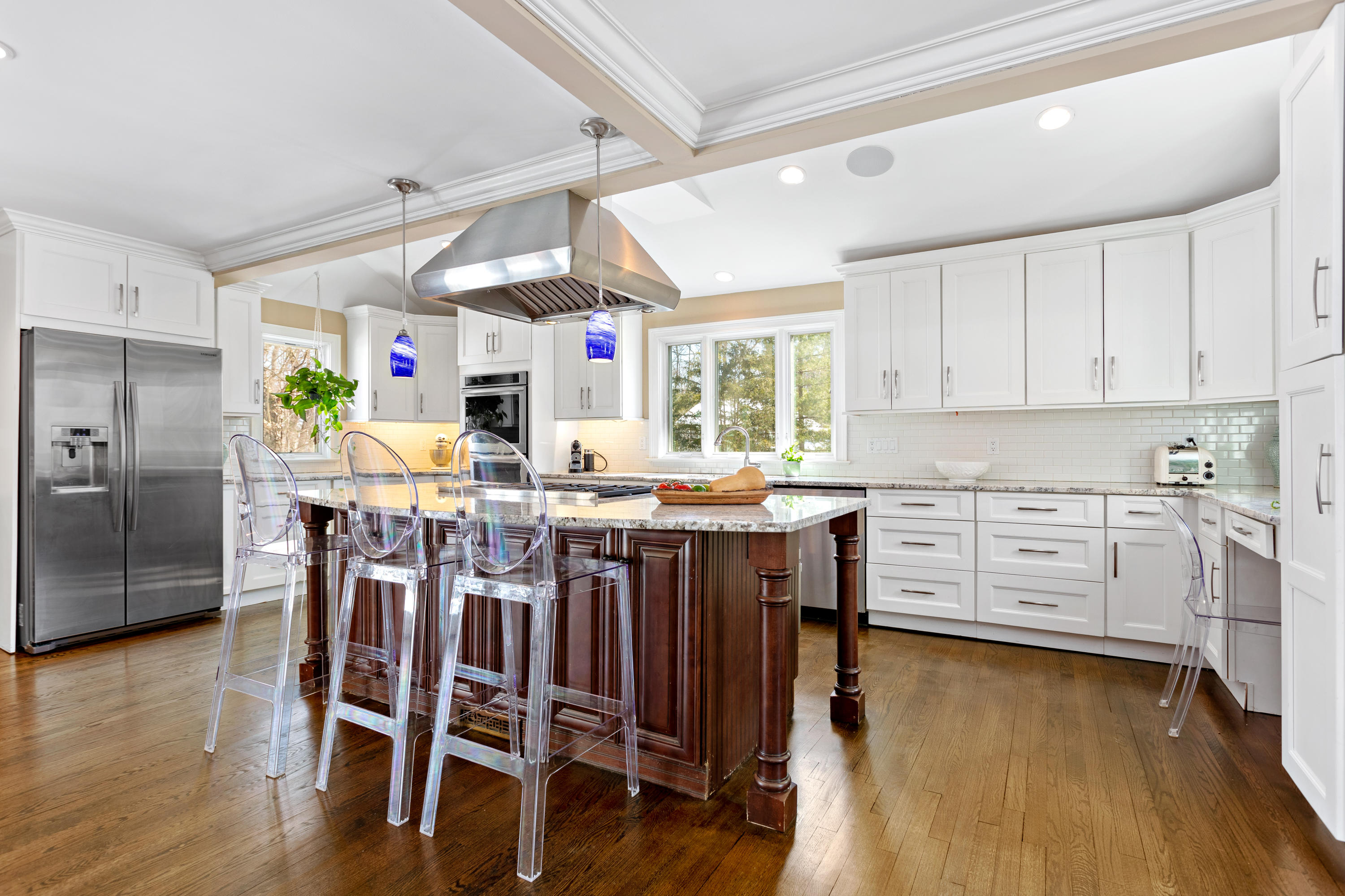 10 Little Brook Road Rowayton, CT 06853 - Photo 5 of 16 a kitchen with stainless steel appliances kitchen island granite countertop a table chairs sink and cabinets