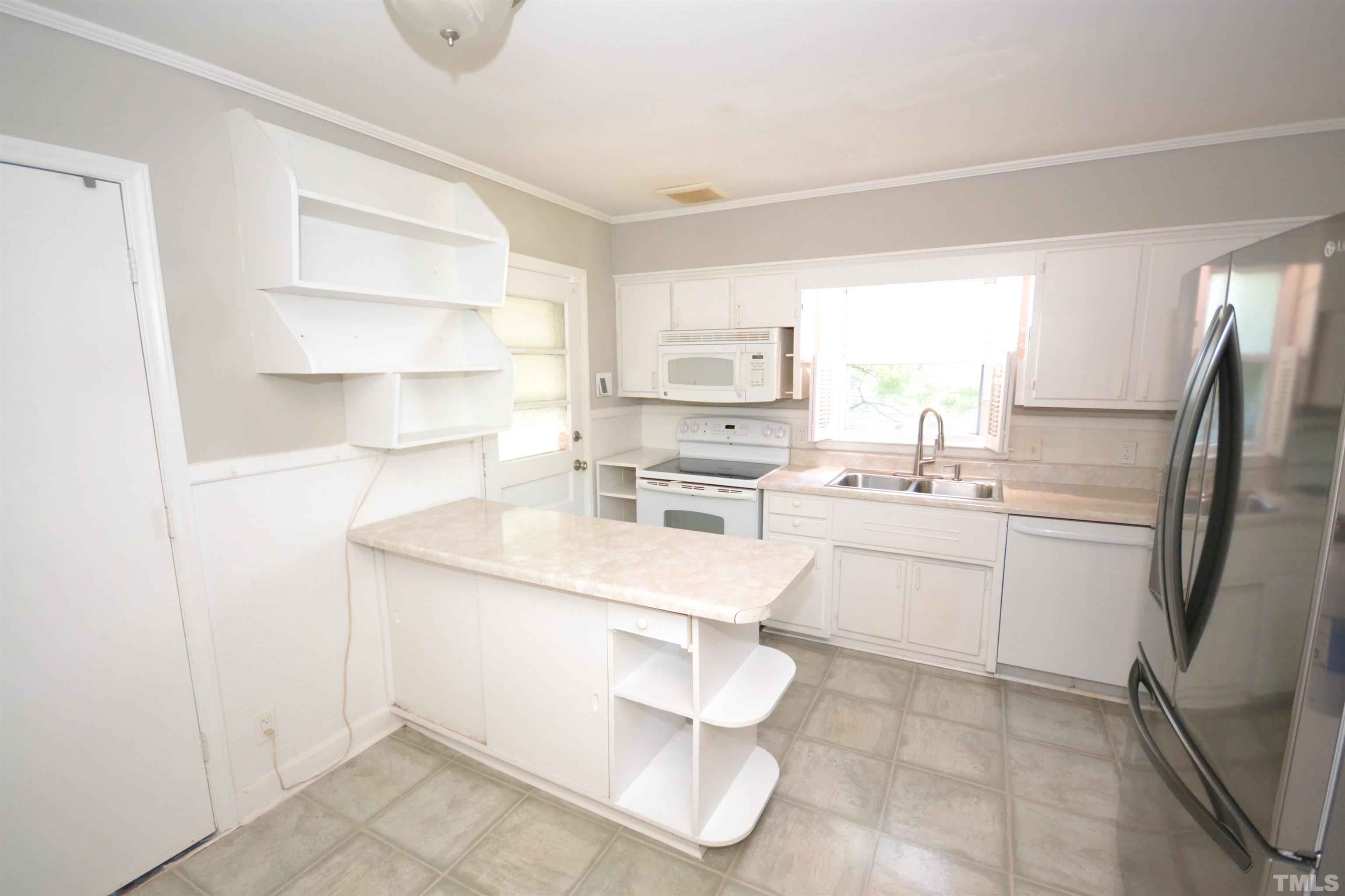 1713 Forest Road Durham, NC 27705 - Photo 14 of 35 a kitchen with a sink cabinets and stainless steel appliances