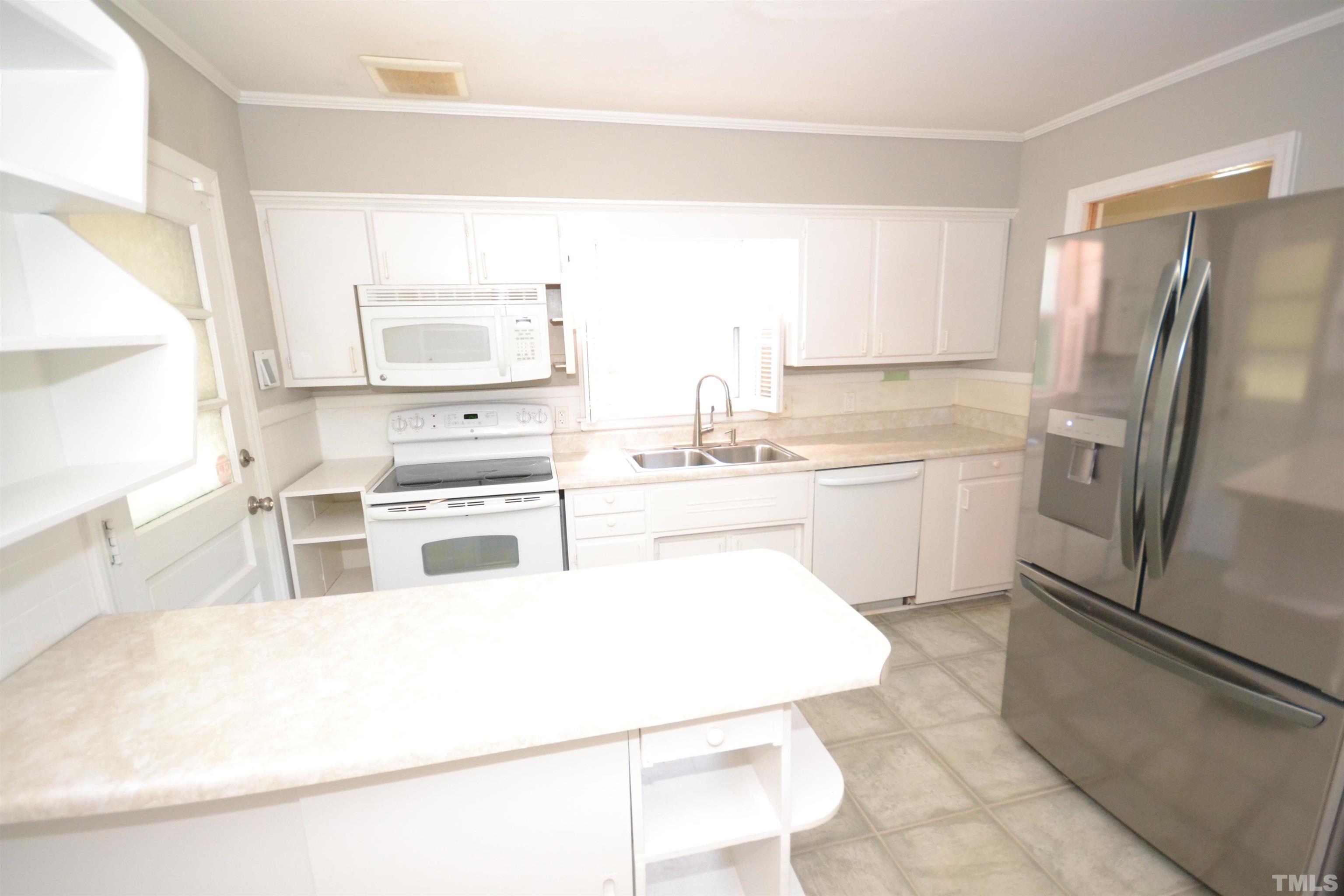 1713 Forest Road Durham, NC 27705 - Photo 15 of 35 a kitchen with a sink stainless steel appliances and cabinets