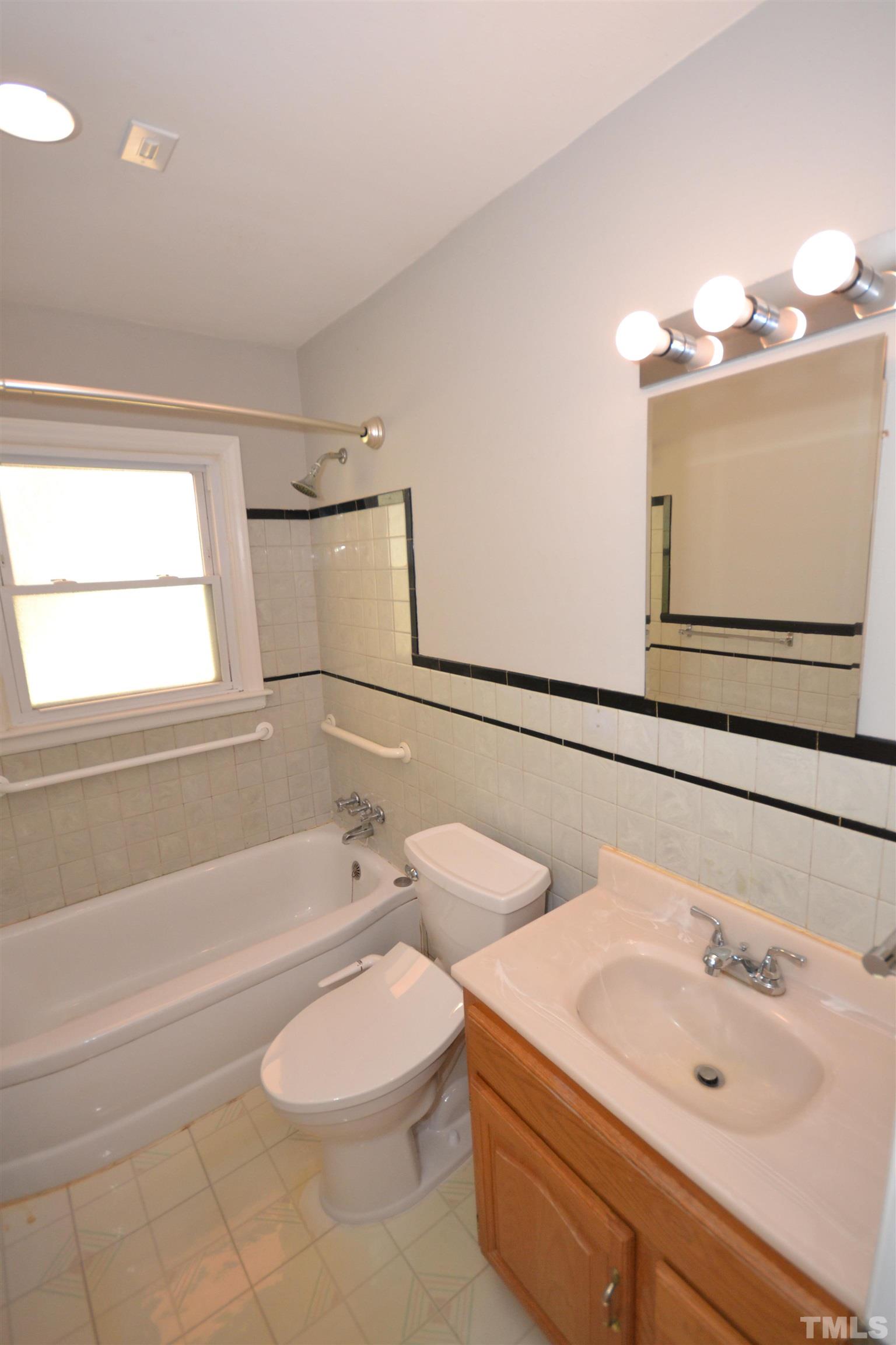 1713 Forest Road Durham, NC 27705 - Photo 20 of 35 a bathroom with a sink a toilet and bathtub