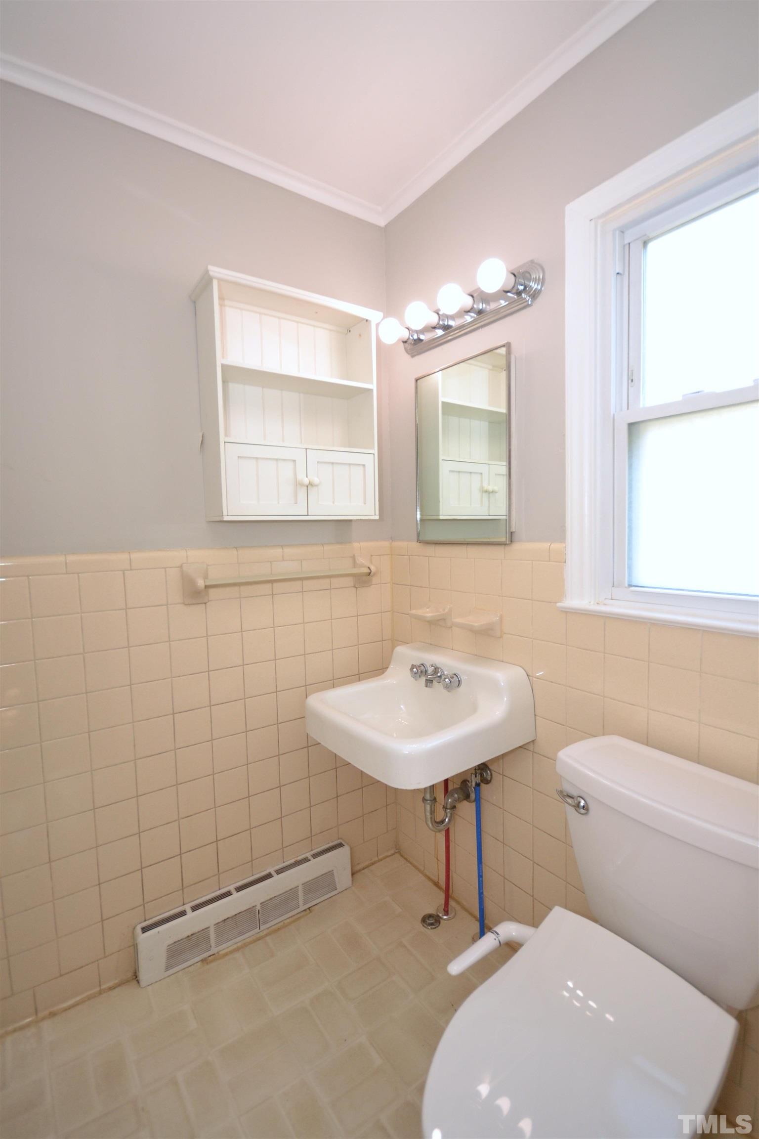 1713 Forest Road Durham, NC 27705 - Photo 25 of 35 a bathroom with a sink a toilet and mirror