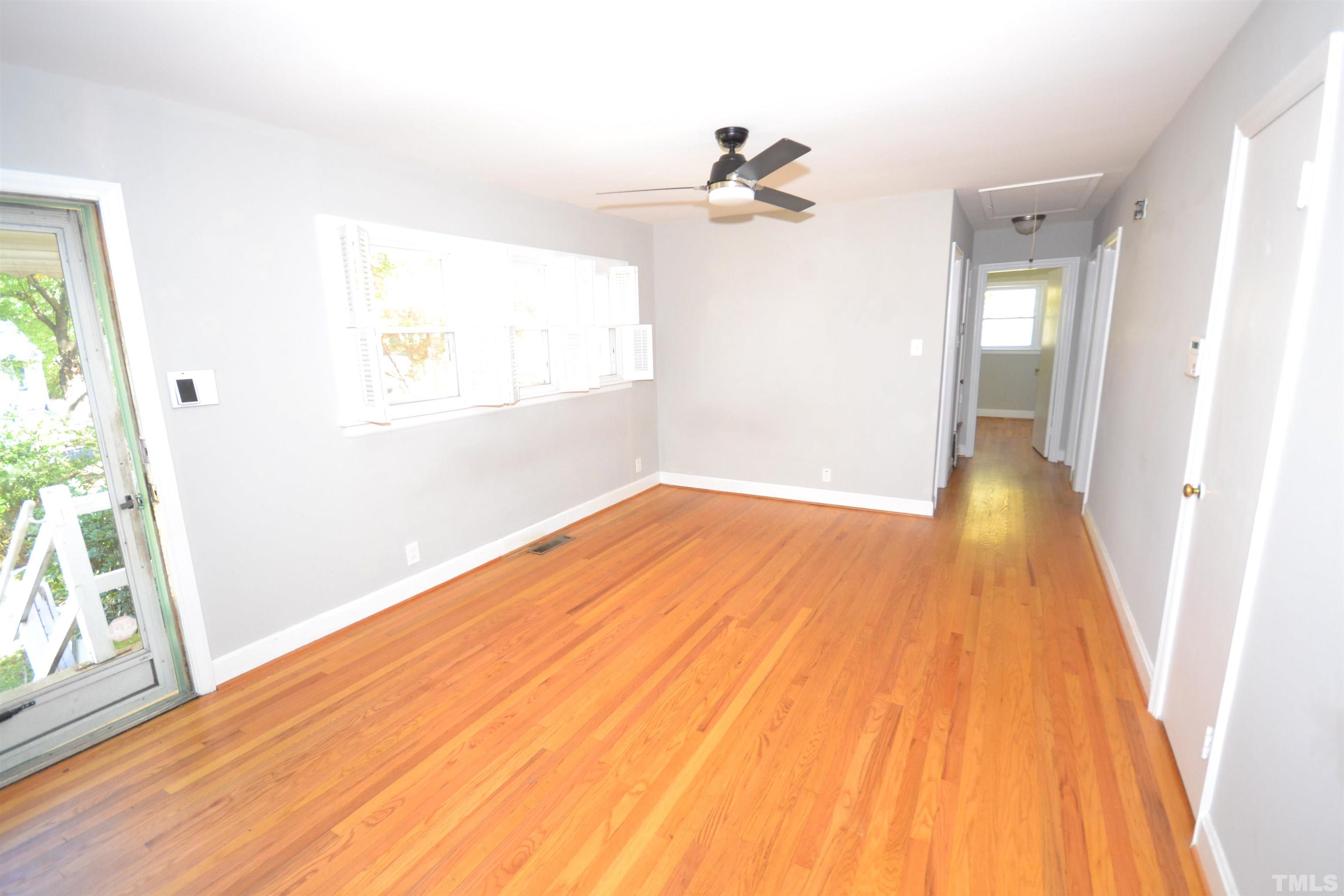 1713 Forest Road Durham, NC 27705 - Photo 6 of 35 a view of empty room with wooden floor and fan