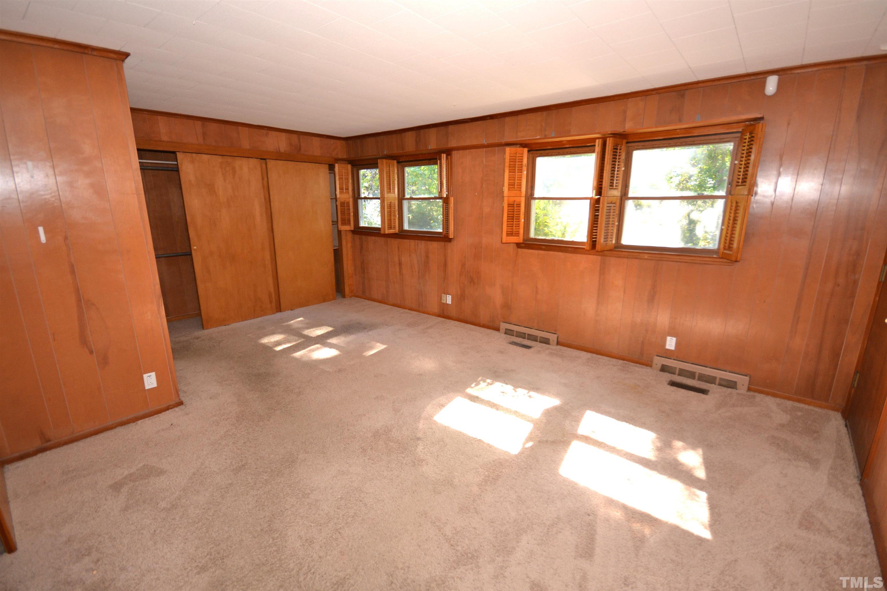 1713 Forest Road Durham, NC 27705 - Photo 9 of 35 a view of an empty room with a window