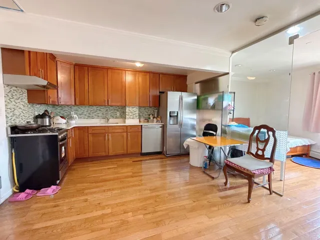 a kitchen with a refrigerator and a sink