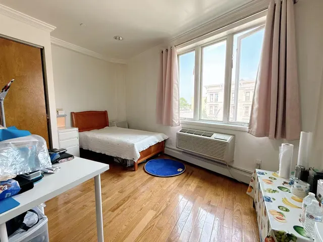 a bedroom with furniture and a window